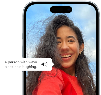 iPhone 15 showing Voiceover feature announcing the picture information: a person with wavy black hair laughing
